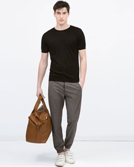 Man with Black T-Shirt, Grey Pants Carrying Brown Soft Rucksack